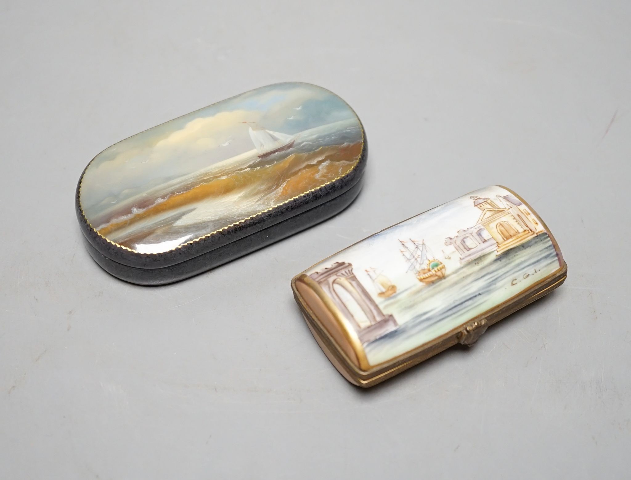 A Russian oval lacquered box, 10cm., and a porcelain box painted with ships approaching harbour